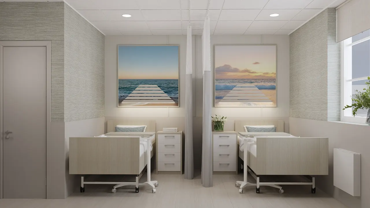 Semi-private skilled nursing resident room at Oceanview with two beds, a privacy partition, soft neutral finishes and coastal artwork