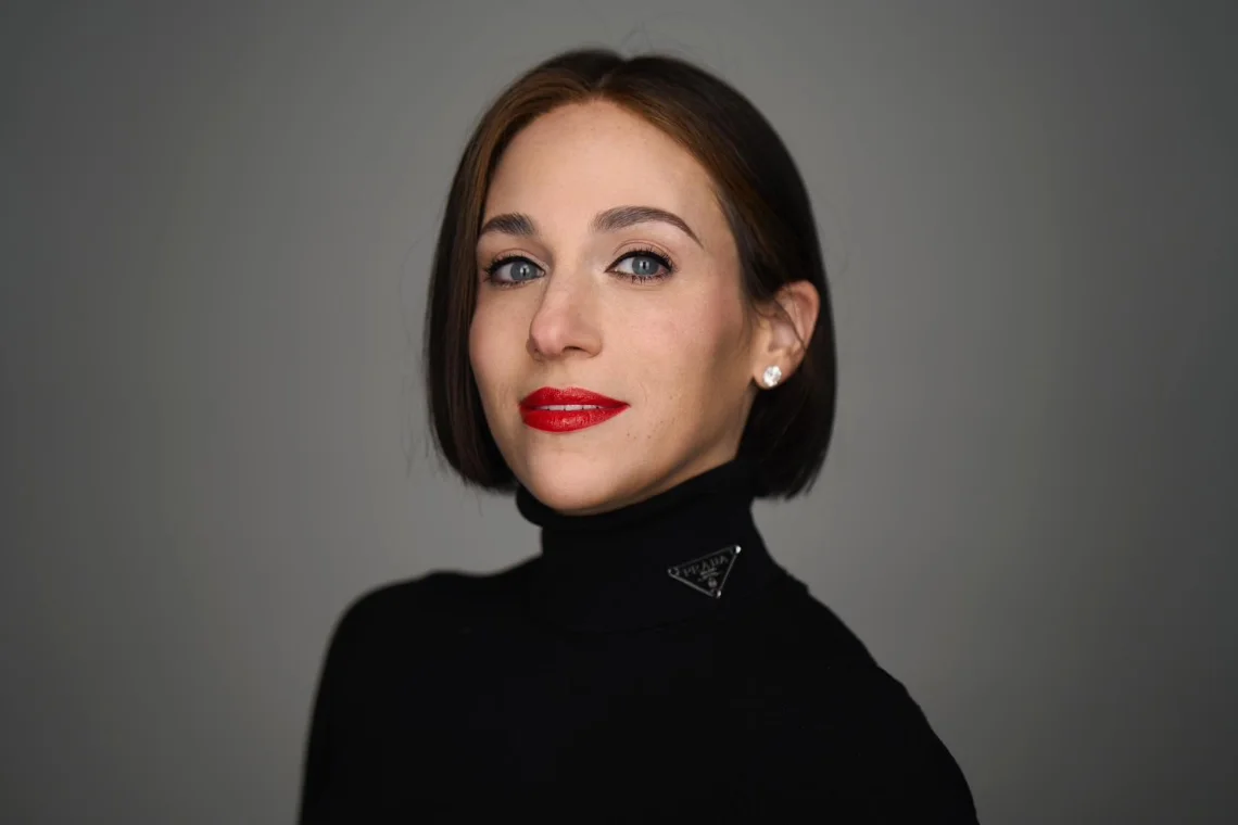 Portrait of Sara Roth, founder and principal interior designer of Sara Roth Design, in a black turtleneck against a grey backdrop
